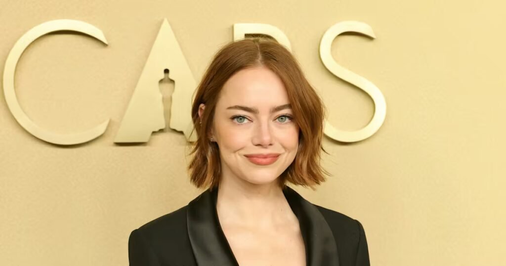 Emma Stone Wears No Pants With a Plunging Black Tie Blazer